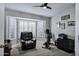 Bright workout room with large windows, plantation shutters, and tile flooring at 18132 E Vencino St, Gilbert, AZ 85298