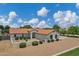 Lovely home with a tile roof surrounded by a brick driveway and manicured landscaping at 18132 E Vencino St, Gilbert, AZ 85298