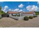 Charming single-story home with a red tile roof, manicured landscaping, and a private gated driveway at 18132 E Vencino St, Gilbert, AZ 85298