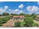 Inviting front yard with mature trees, lush greenery, and a well-manicured lawn offering great curb appeal at 18132 E Vencino St, Gilbert, AZ 85298
