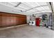 Spacious garage with custom cabinets, washer, dryer and a red refrigerator at 18132 E Vencino St, Gilbert, AZ 85298