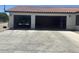 A three-car garage with two open bays and a vehicle parked inside at 18132 E Vencino St, Gilbert, AZ 85298