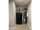 Hallway closet with a security safe and lots of storage for clothing and other items at 18132 E Vencino St, Gilbert, AZ 85298