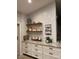 Kitchen with white subway tile backsplash, granite countertops and wooden shelving at 18132 E Vencino St, Gilbert, AZ 85298