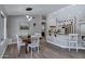 Open-concept kitchen and dining area with granite countertops, white cabinetry, and modern lighting at 18132 E Vencino St, Gilbert, AZ 85298