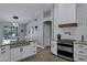 Bright kitchen features granite counters, white cabinets, tiled backsplash, and stainless-steel appliances at 18132 E Vencino St, Gilbert, AZ 85298