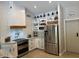 Modern kitchen with white cabinets, stainless steel appliances, and a pantry at 18132 E Vencino St, Gilbert, AZ 85298