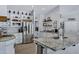 Modern kitchen with stainless steel appliances, white subway tile backsplash, granite counters, and custom shelving at 18132 E Vencino St, Gilbert, AZ 85298