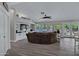 Bright living room featuring a large sectional, built-in shelving, and access to the outdoor pool area at 18132 E Vencino St, Gilbert, AZ 85298