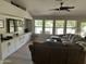 Bright living room with custom built in cabinets, tile floors, and large windows at 18132 E Vencino St, Gilbert, AZ 85298