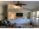 Bright living room with vaulted ceilings, a ceiling fan, and custom built in cabinets at 18132 E Vencino St, Gilbert, AZ 85298