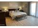 Bright main bedroom features a bench seat, nightstands, and curtains at 18132 E Vencino St, Gilbert, AZ 85298