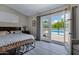 Bright main bedroom boasts wood floors and sliding glass doors that open to the pool area at 18132 E Vencino St, Gilbert, AZ 85298