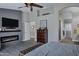 Main bedroom features a fireplace with TV, a ceiling fan, and wood-style flooring at 18132 E Vencino St, Gilbert, AZ 85298