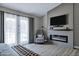 Cozy main bedroom showcasing a modern fireplace, comfortable seating, and access to the outdoors at 18132 E Vencino St, Gilbert, AZ 85298
