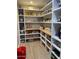 Bright pantry features custom shelving and storage space for kitchen supplies and other pantry essentials at 18132 E Vencino St, Gilbert, AZ 85298