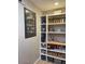 A pantry with custom shelving and storage space for kitchen supplies and other pantry essentials at 18132 E Vencino St, Gilbert, AZ 85298