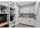Convenient walk-in pantry adjacent to kitchen, with shelving, countertop, and storage space at 18132 E Vencino St, Gilbert, AZ 85298