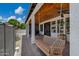 Enjoy the covered patio with a porch swing, wood ceiling, and beautiful views of the lush backyard at 18132 E Vencino St, Gilbert, AZ 85298