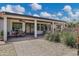 Enjoy this covered patio featuring a ceiling fan and dining space, perfect for outdoor relaxation at 18132 E Vencino St, Gilbert, AZ 85298