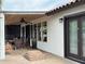 Covered patio features outdoor seating, a ceiling fan, and an exterior door for indoor/outdoor living at 18132 E Vencino St, Gilbert, AZ 85298