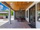 Spacious covered patio offers a dining area, wooden ceiling, and a view of the landscaped backyard at 18132 E Vencino St, Gilbert, AZ 85298