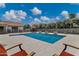 Inviting backyard features a sparkling pool, water features, lush landscaping, and lounge seating at 18132 E Vencino St, Gilbert, AZ 85298