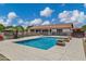 Relax by the pool in this backyard oasis, featuring water features, lounge chairs, and lush landscaping at 18132 E Vencino St, Gilbert, AZ 85298