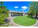 Expansive backyard with green lawn, covered patio, and mature landscaping at 1831 W Seldon Ln, Phoenix, AZ 85021