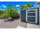 Well-maintained backyard featuring a useful shed, green trees, and neat landscaping at 1831 W Seldon Ln, Phoenix, AZ 85021