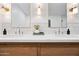 Close-up of a bathroom with double sinks, white countertops, and modern faucets at 1831 W Seldon Ln, Phoenix, AZ 85021
