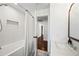 Bathroom featuring a tub with shower, white tile and marble counters at 1831 W Seldon Ln, Phoenix, AZ 85021