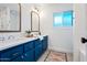 Bathroom featuring double sinks with bright blue cabinets and white counters at 1831 W Seldon Ln, Phoenix, AZ 85021