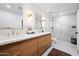 Beautiful bathroom with dual sinks, updated fixtures, and a glass-enclosed shower at 1831 W Seldon Ln, Phoenix, AZ 85021