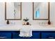 Bathroom featuring double sinks with bright blue cabinets and white counters at 1831 W Seldon Ln, Phoenix, AZ 85021