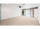 Open bedroom with plush carpet, a ceiling fan, and large sliding glass doors to the outdoors at 1831 W Seldon Ln, Phoenix, AZ 85021