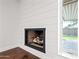 Close-up of a modern fireplace with clean lines and a minimalist design, highlighted by white shiplap at 1831 W Seldon Ln, Phoenix, AZ 85021