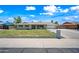 Charming single-story home featuring a well-manicured lawn, gray brick, and a classic suburban appeal at 1831 W Seldon Ln, Phoenix, AZ 85021
