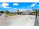 Inviting single-story home with large driveway, well-kept lawn, and desert landscaping under a bright blue sky at 1831 W Seldon Ln, Phoenix, AZ 85021