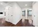Hallway with rich wood floors leading to bedrooms and living areas at 1831 W Seldon Ln, Phoenix, AZ 85021