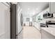 Bright kitchen featuring stainless steel appliances, white cabinets, and a large island leading to the living room at 1831 W Seldon Ln, Phoenix, AZ 85021