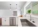 Kitchen features stainless appliances, quartz countertops, shaker cabinets, and a large center island with seating at 1831 W Seldon Ln, Phoenix, AZ 85021