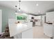 Bright kitchen featuring white cabinets, stainless appliances, tile backsplash, and a large island with seating at 1831 W Seldon Ln, Phoenix, AZ 85021