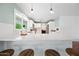 Kitchen features a large island with seating, white cabinets, stainless appliances, and bright, natural light at 1831 W Seldon Ln, Phoenix, AZ 85021