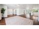 Spacious room with hardwood floors, ceiling fan, recessed lighting, and adjacent kitchen area at 1831 W Seldon Ln, Phoenix, AZ 85021
