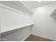 Empty walk-in closet with white walls, shelving, and a neutral carpet at 1831 W Seldon Ln, Phoenix, AZ 85021