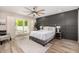 Bright bedroom featuring a king bed, wood floors, and access to the outdoor patio at 19 E Boca Raton Rd, Phoenix, AZ 85022