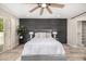 Spacious bedroom boasts a king bed, wood floors, and a stylish accent wall at 19 E Boca Raton Rd, Phoenix, AZ 85022