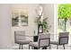 Bright dining room featuring a glass table and view of the green outdoors at 19 E Boca Raton Rd, Phoenix, AZ 85022