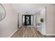 Inviting entryway with wood-look tile flooring, large front door with modern design, and neutral paint colors at 19 E Boca Raton Rd, Phoenix, AZ 85022